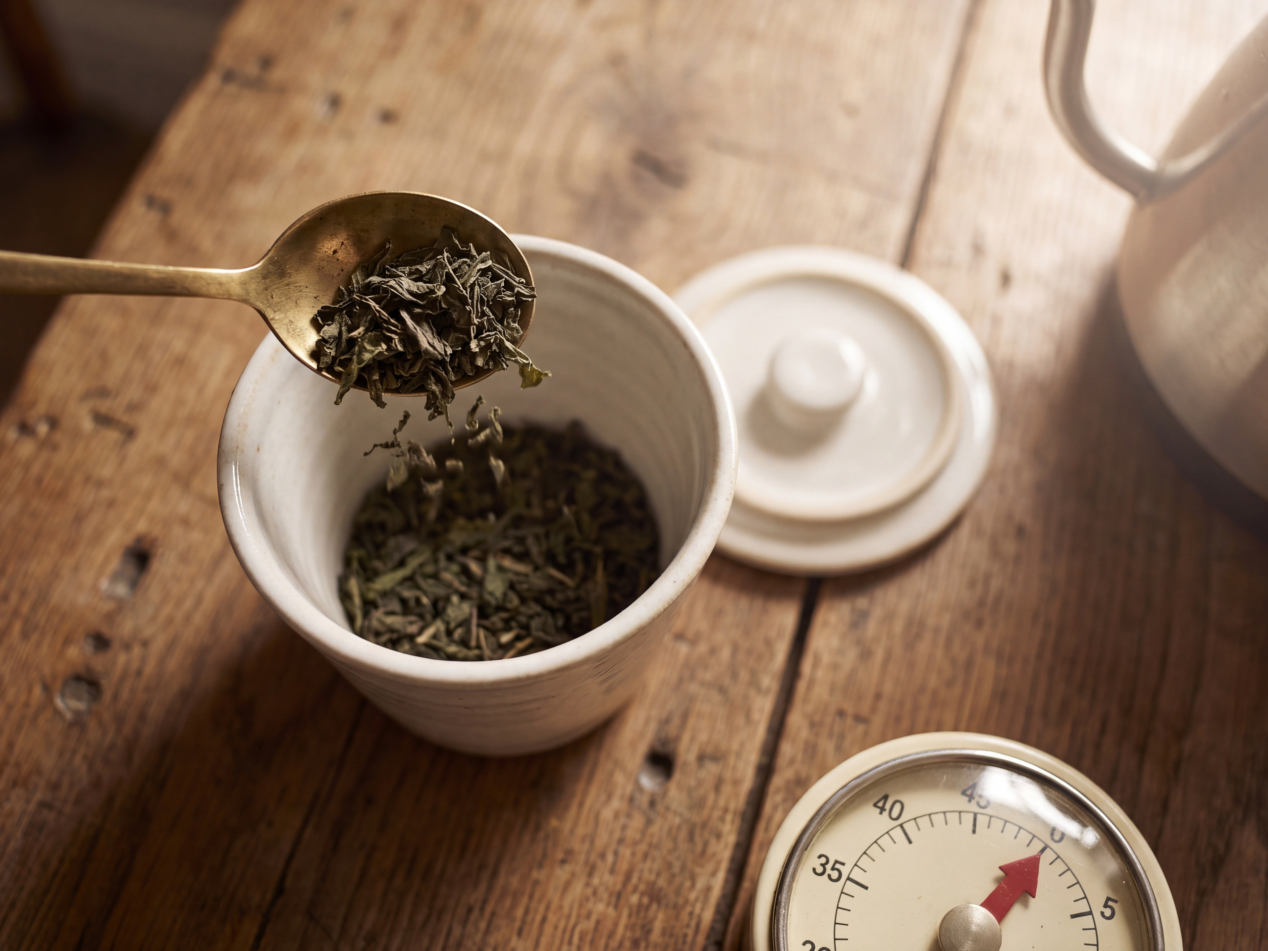 Loose peppermint leaf measured into a covered cup for a five to ten minute steep