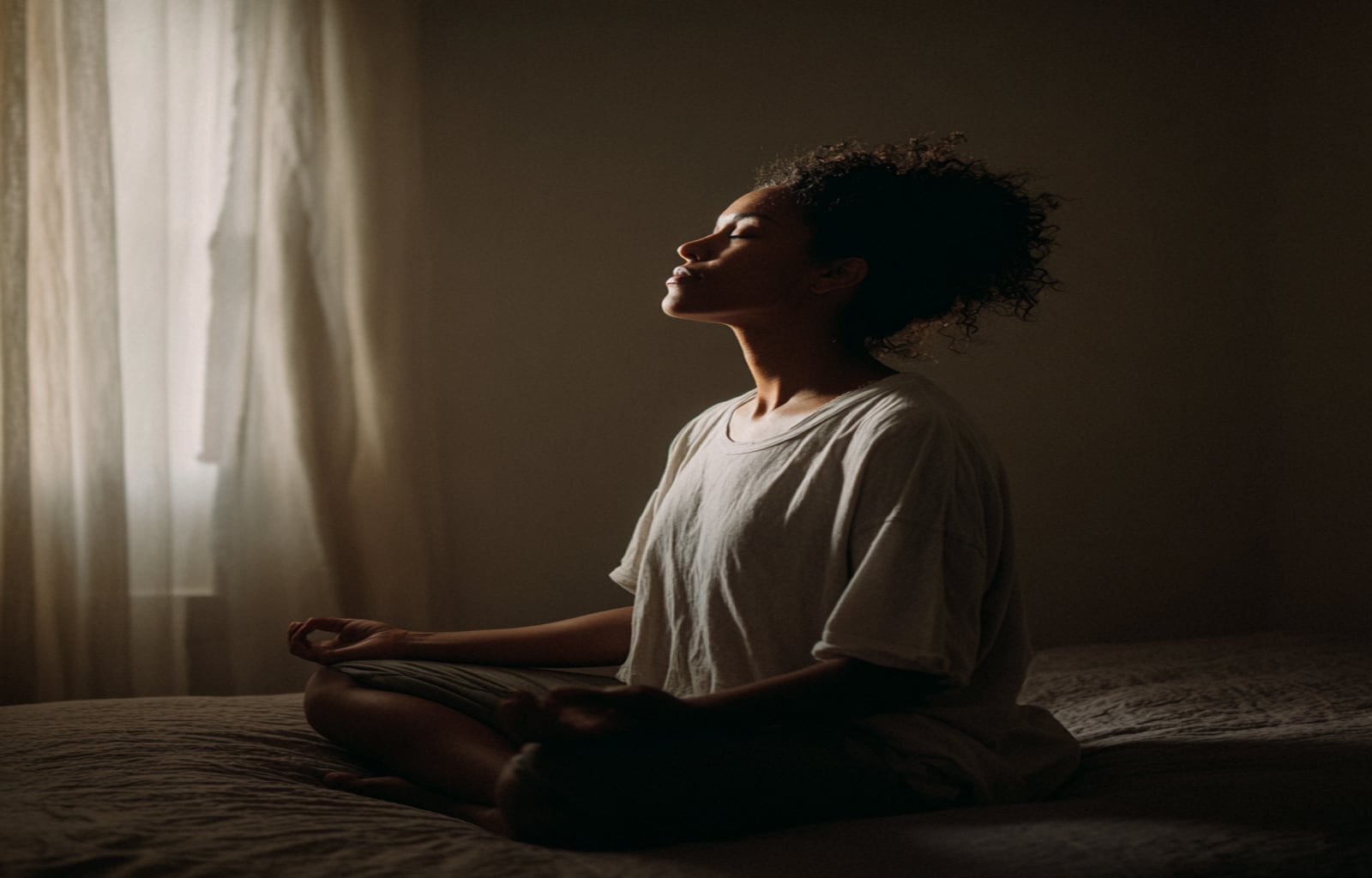 A person meditating peacefully to calm their mind and body before bed as a natural way to help with sleep.